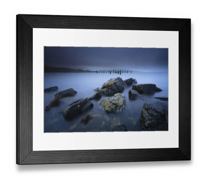 Framed Print : Stormy weather with heavy rain clouds at bay with rocks and lichen at foreground and old pier Framed Print : Stormy weather with heavy rain clouds at bay with rocks and lichen at foreground and old pier