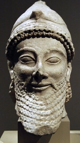 Cyprus. Limestone male head wearing a helmet with a bird. Ar
