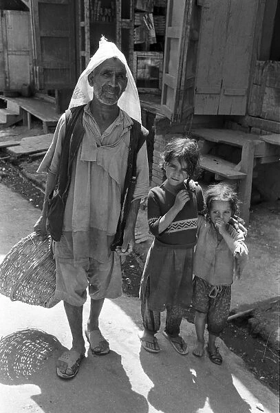 Ragged man and children, Kashmir