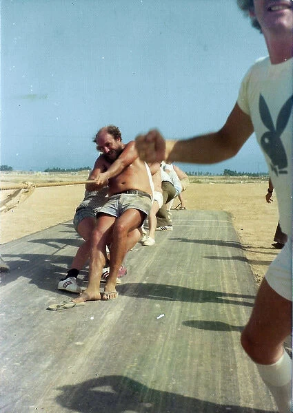 White men pulling rope in Oman