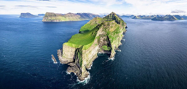 Aerial view of Kallur lighthouse on majestic cliffs washed by the blue Atlantic ocean, Kalsoy island, Faroe Islands, Denmark, Europe