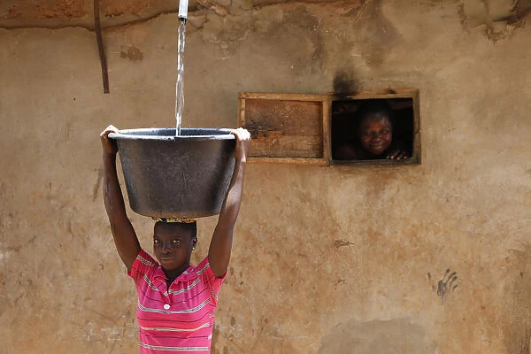 Collecting water in a Zou province village, Benin, West Africa, Africa