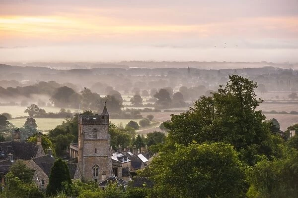 St. Lawrence Church and misty sunrise, Bourton-on-the-Hill, Gloucestershire, The Cotswolds, England, United Kingdom, Europe