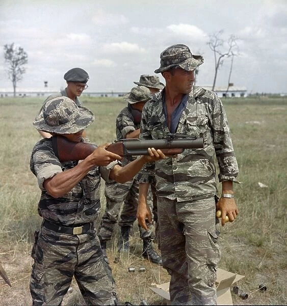 VIETNAM WAR, 1967. Staff Sergeant Alvin Rouly supervising a Civilian Irregular