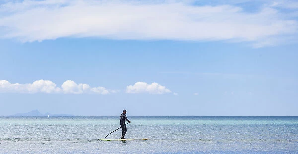 A paddleboarder at Orewa in Auckland Region, New Zealand
