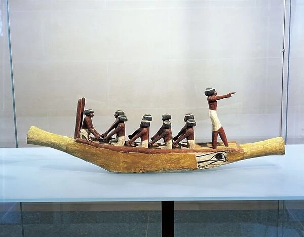 Painted and stuccoed wood model of boat with Eye of Horus painted on the hull