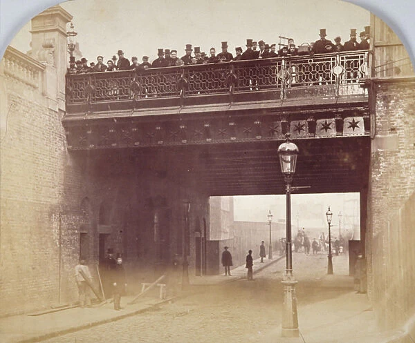 View of figures looking over the south side of Shoe Lane Bridge, City of London, 1869