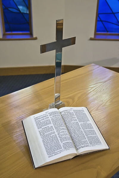 An Open Bible Beside A Cross On A Table; Sheffield, South Yorkshire, England