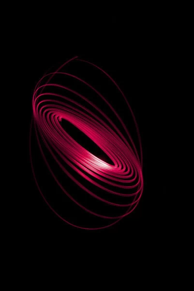 Red Light Curving In A Sphere Shape On A Black Background