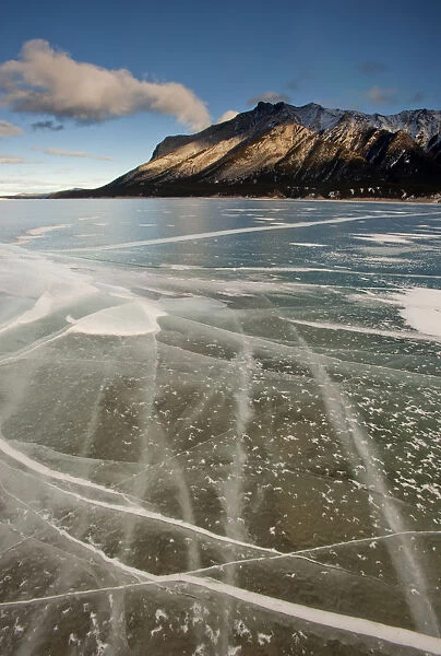 Cracked surface of frozen lake, Abraham Lake, Canadian Rockies, Alberta, Canada