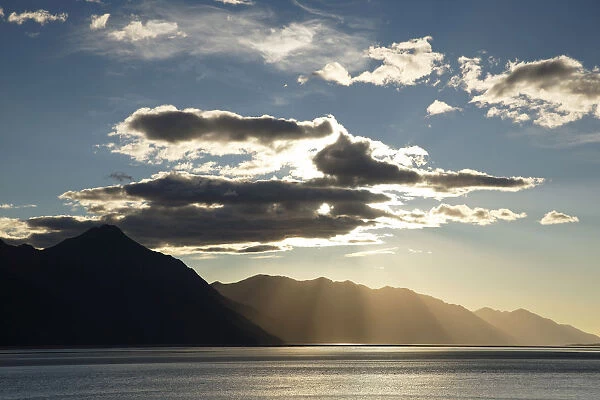 Sun shining behind clouds above Turnagain Arm, outside Anchorage, Alaska, United States