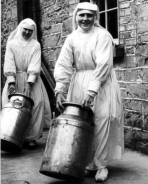 Sister Mona and Sister Benignus of Loughglynne Convent roll in the churns of milk