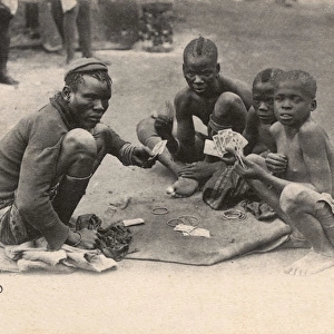 South Africa - Sotho Boys play cards for arm bangles