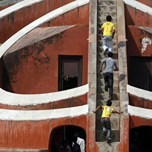 Children play inside one of the instruments of Jantar Mantar in New Delhi