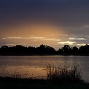 Setting sun over water near Lebala, Okavango Delta, Botswana