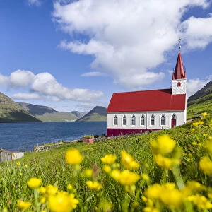 The church in village Husar on Kalsoy, in the background the island of Bordoy and Klaksvik