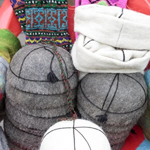 Georgia, Mtskheta. A collection of traditional hats for sale as souveniers