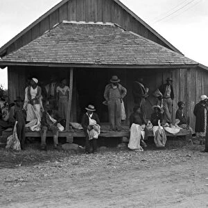 COTTON PICKERS, 1935. African American migrant workers waiting for transportation