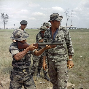 VIETNAM WAR, 1967. Staff Sergeant Alvin Rouly supervising a Civilian Irregular