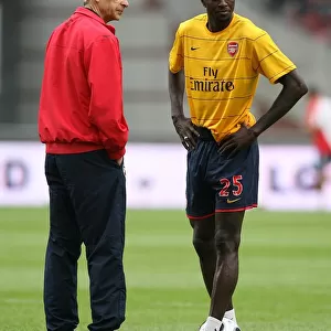 Arsenal manager Arsene Wenger with Emmanuel Adebayor