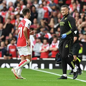 Arsenal Physio Simon Murphy Attends to Injured Player Amidst Intense Arsenal vs. Tottenham Clash (2023-24)