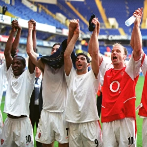 Arsenal players celebrate winning the League (L>R) Lauren, Robert Pires
