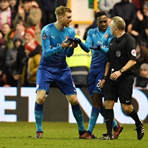 Arsenal's Per Mertesacker and Danny Welbeck Protest Referee's Call during FA Cup Match vs Nottingham Forest