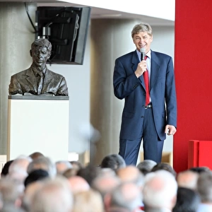 Arsene Wenger the Arsenal Manager stands next to the bust of himself