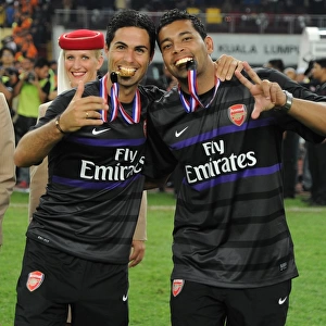 Mikel Arteta and Andre Santos Celebrate Arsenal's Victory over Malaysia XI