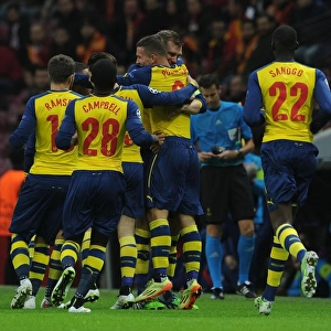 Podolski and Mertesacker Celebrate Arsenal's First Goal Against Galatasaray in Champions League