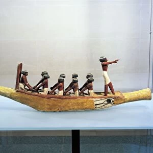 Painted and stuccoed wood model of boat with Eye of Horus painted on the hull
