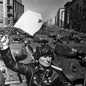 Tank officer and hero of the soviet union colonel sukhovarov leading the mechanized and armored units to red square during a may day parade in the early 1950s, t-34 tanks