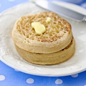 Hot buttered crumpets on white plate credit: Marie-Louise Avery / thePictureKitchen