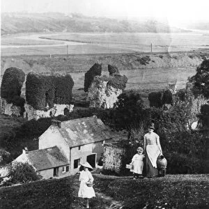 A mother and her girls climb the steep hill at the back of their garden to fetch water
