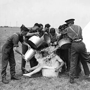 TA camp having fun bathing with buckets of water in the countryside. August 1938