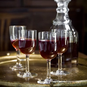 A tray of glasses of sloe gin with unstoppered decanter. credit: Marie-Louise Avery