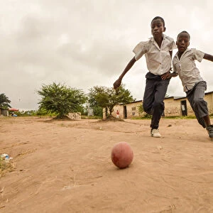 Children play football in the streets of the Kinsuka neighbourhood in the city of