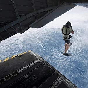 Air Force pararescueman jumps from a CH-53E Super Stallion helicopter