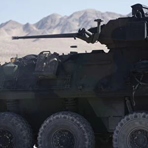 A light armored vehicle fires its 25mm Bushmaster chain gun
