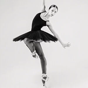 black swan. ballerina in a black tutu shows elements of ballet dance in motion