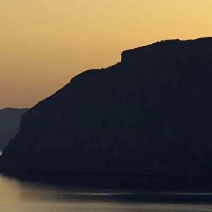 Coastal cliffs silhouetted at dawn near Mochlos, Crete, Greece, April 2009