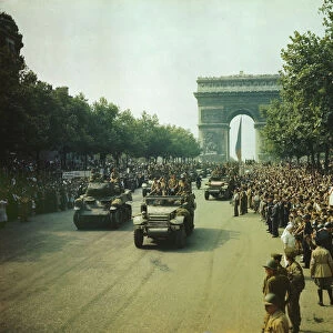 Crowds of French patriots line the Champs Elysees to view Allied tanks and half tracks pass... 1944 Creator: Jack Downey