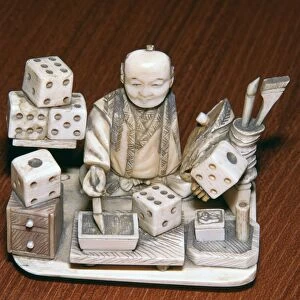 Japanese ivory of a dice painter, 19th century
