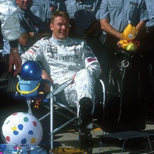 2001 Japanese Grand Prix. Suzuka, Japan. 12-14 October 2001. The McLaren team prepare Mika Hakkinen (McLaren Mercedes) for his sabaticle. This Grand Prix was his last for a while, as he intends to relax with wife Erja and son Hugo for a year