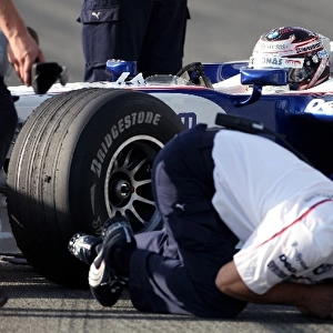 Formula One Testing: A BMW Sauber mechanic receives an electric shock from Christian Klien BMW F1. 08 running a KERS system
