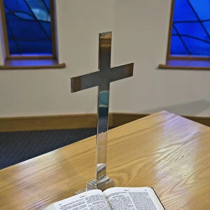An Open Bible Beside A Cross On A Table; Sheffield, South Yorkshire, England