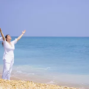 Women Worshipping On The Beach