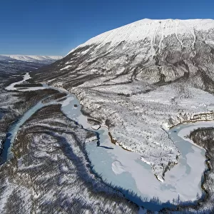 Frozen river and mountain in winter, Putorana Plateau, Siberia, Russia