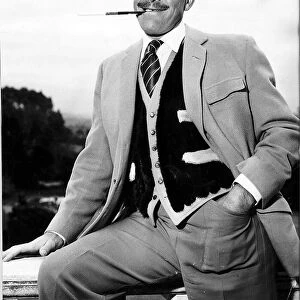 Actor Terry Thomas smoking a cigarette May 1959
