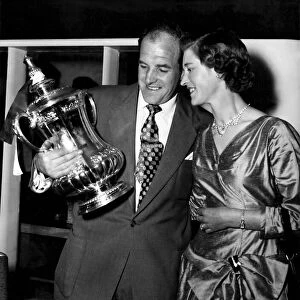 Newcastle United captain Jimmy Scoular shows off the FA Cup trophy to his wife after his